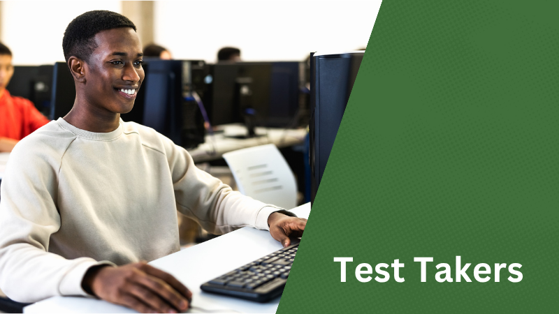 "Test Takers." Student Smiling while sitting at a computer